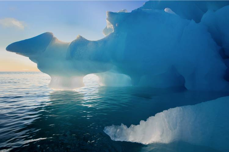 Arctic sunset behind icebergs